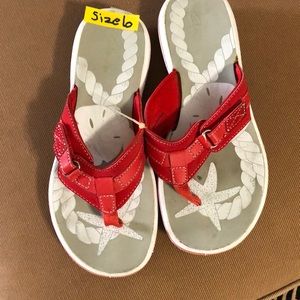 Clark’s red sandals.